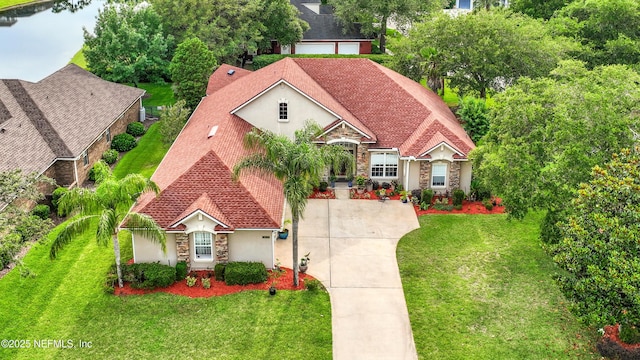 3854 Painted Bunting Way, Jacksonville, FL 32224 - view of front of property with stucco siding, stone siding, and a front lawn