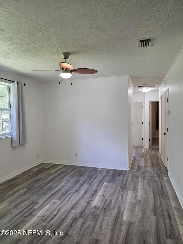 54038 Charles St, Callahan, FL 32011 - spare room featuring dark wood-type flooring, a textured ceiling, a ceiling fan, and attic access