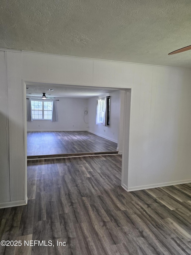 54038 Charles St, Callahan, FL 32011 - empty room with wood finished floors, a textured ceiling, healthy amount of natural light, and a ceiling fan