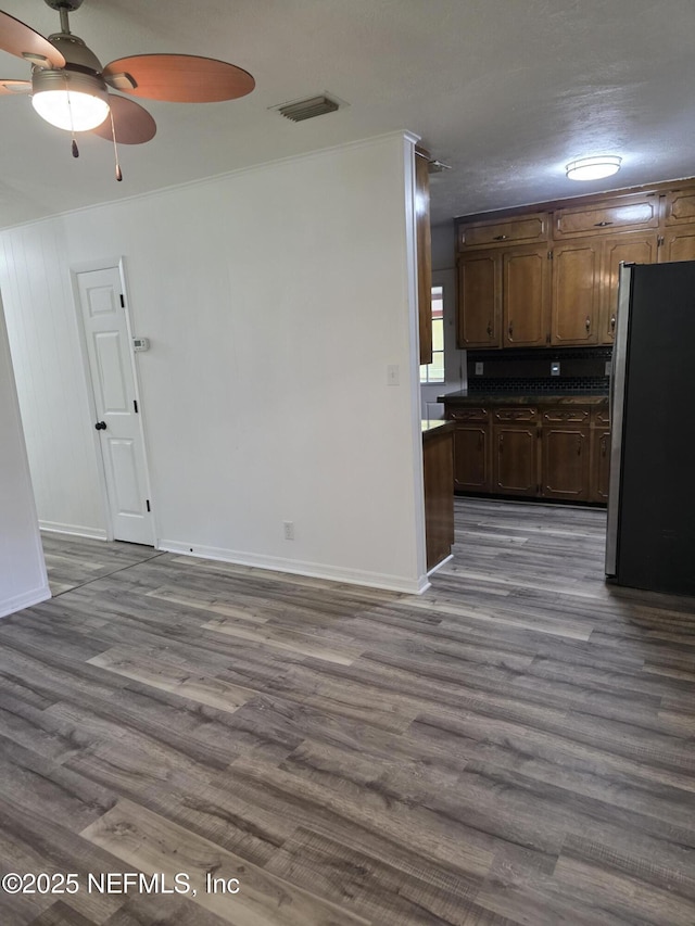 54038 Charles St, Callahan, FL 32011 - kitchen featuring freestanding refrigerator, ceiling fan, dark wood finished floors, dark countertops, and crown molding