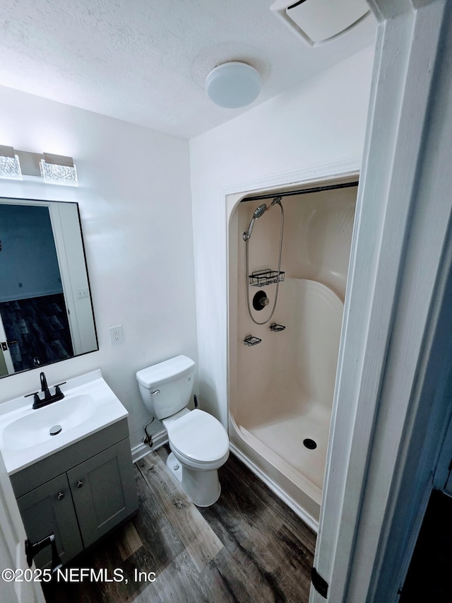 54038 Charles St, Callahan, FL 32011 - bathroom with wood finished floors, vanity, a shower, and a textured ceiling