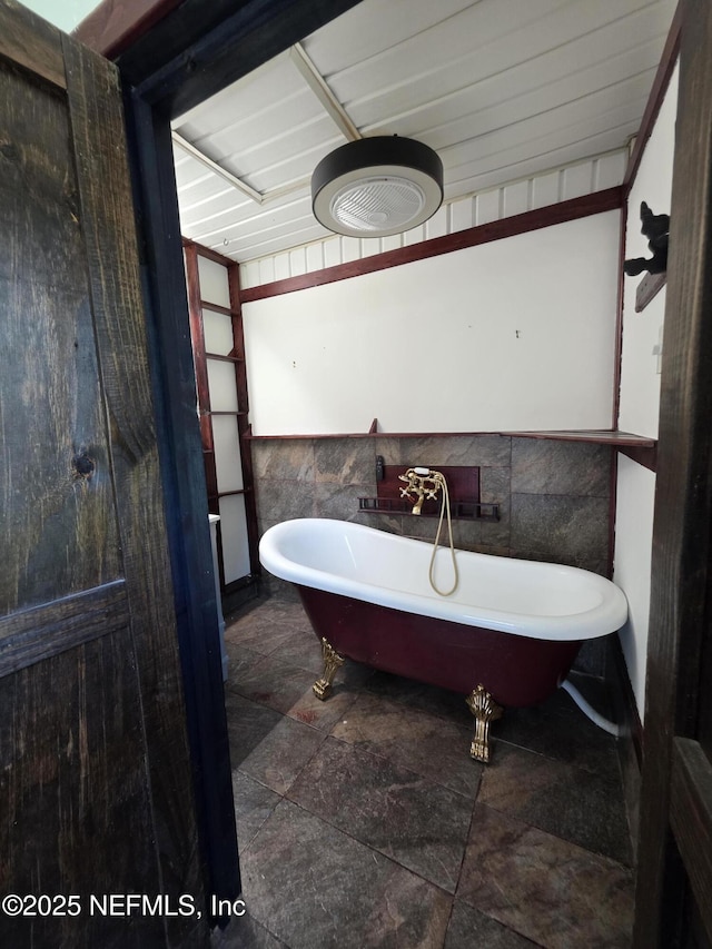 54038 Charles St, Callahan, FL 32011 - full bath with a soaking tub and stone finish flooring