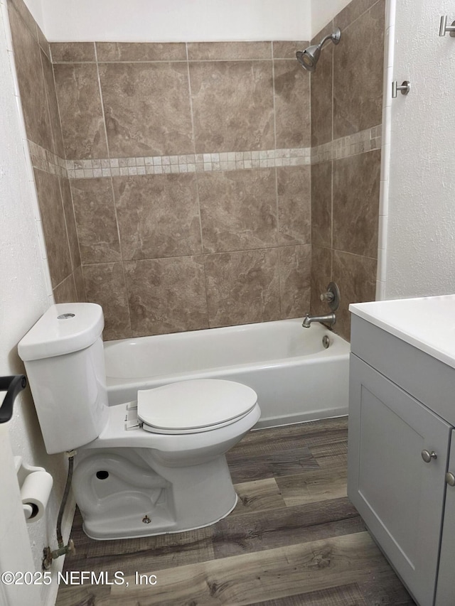 54038 Charles St, Callahan, FL 32011 - bathroom featuring wood finished floors, vanity, and tub / shower combination