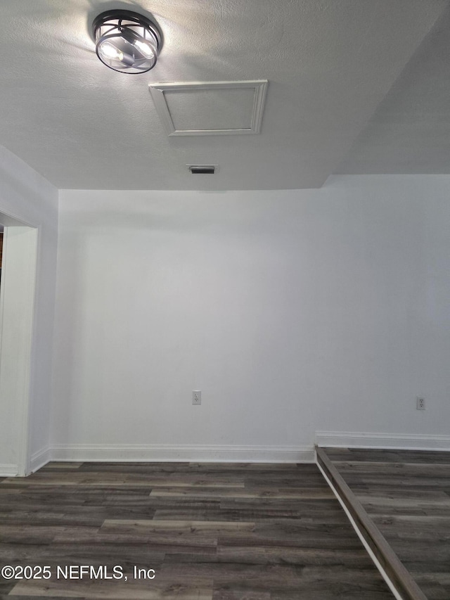 54038 Charles St, Callahan, FL 32011 - spare room with dark wood-style flooring and attic access