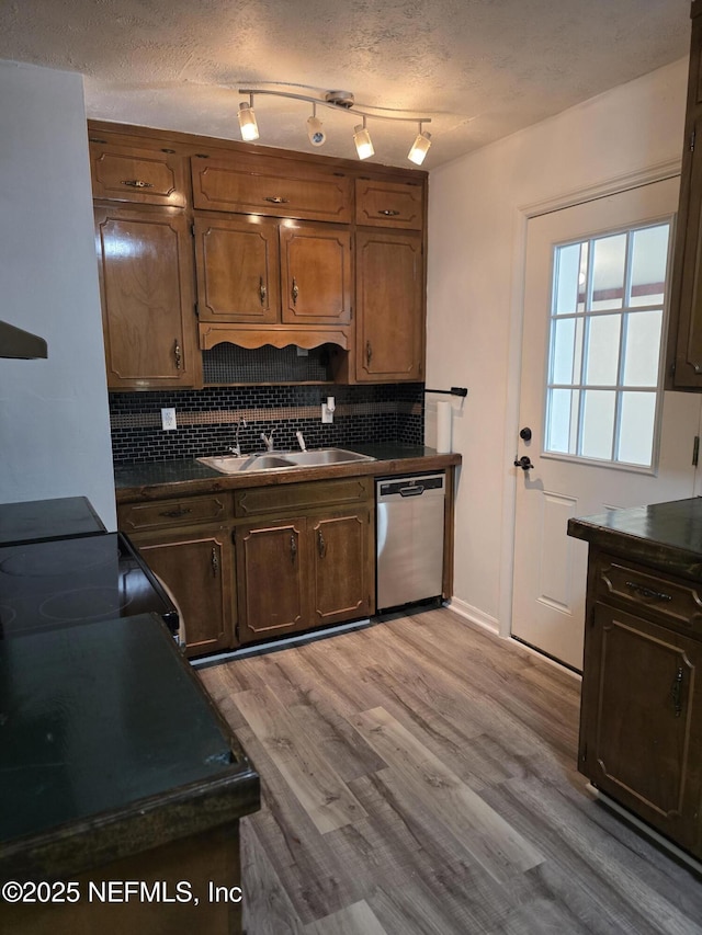 54038 Charles St, Callahan, FL 32011 - kitchen with stainless steel dishwasher, dark countertops, tasteful backsplash, light wood finished floors, and black / electric stove