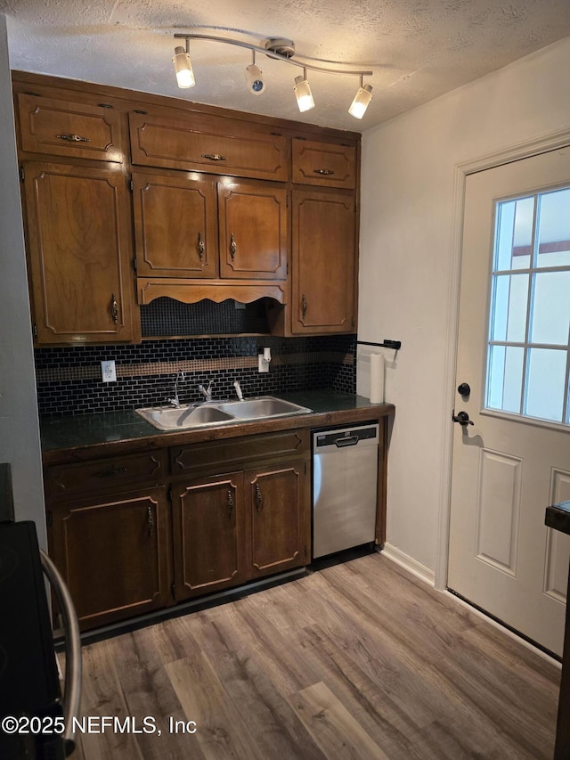 54038 Charles St, Callahan, FL 32011 - kitchen featuring dishwasher, range, dark countertops, decorative backsplash, and light wood finished floors