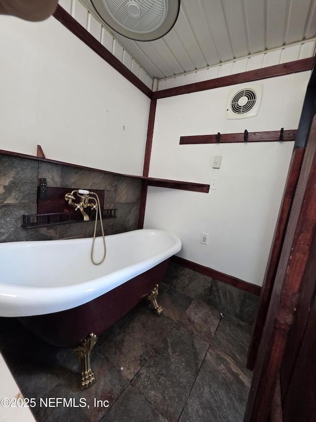54038 Charles St, Callahan, FL 32011 - bathroom featuring a soaking tub and baseboards