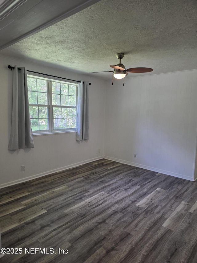 54038 Charles St, Callahan, FL 32011 - spare room featuring ceiling fan, dark wood-style floors, and a textured ceiling