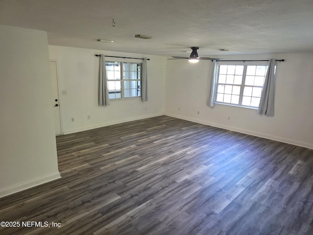54038 Charles St, Callahan, FL 32011 - empty room with healthy amount of natural light, a ceiling fan, and dark wood-style flooring