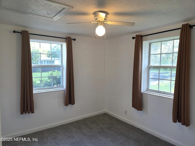 54038 Charles St, Callahan, FL 32011 - empty room with healthy amount of natural light, a textured ceiling, ceiling fan, and dark colored carpet