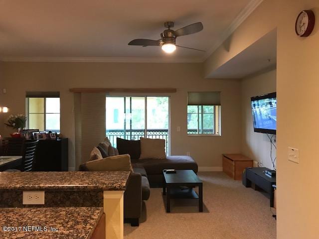 9745 Touchton Rd Unit 2522, Jacksonville, FL 32246 - living room with light colored carpet, a ceiling fan, ornamental molding, and baseboards