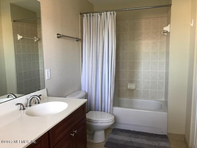 9745 Touchton Rd Unit 2522, Jacksonville, FL 32246 - bathroom featuring toilet, shower / bath combo with shower curtain, and vanity