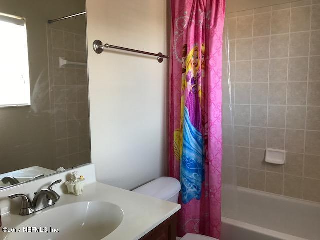 9745 Touchton Rd Unit 2522, Jacksonville, FL 32246 - full bathroom featuring vanity, toilet, and shower / bath combo with shower curtain
