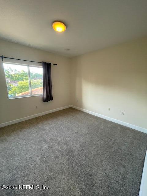 9745 Touchton Rd Unit 2522, Jacksonville, FL 32246 - spare room with baseboards and carpet flooring
