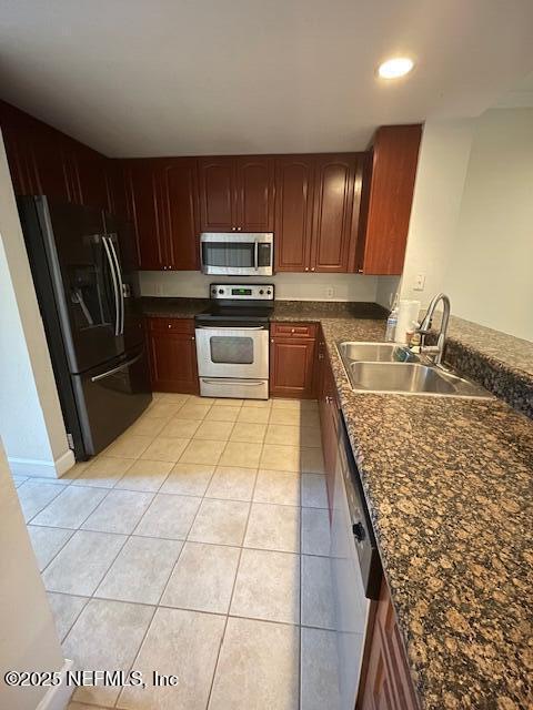 9745 Touchton Rd Unit 2522, Jacksonville, FL 32246 - kitchen with appliances with stainless steel finishes, a sink, light tile patterned flooring, dark countertops, and recessed lighting