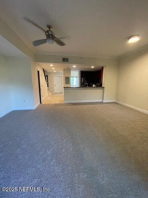 9745 Touchton Rd Unit 2522, Jacksonville, FL 32246 - unfurnished living room featuring ceiling fan, light carpet, and baseboards