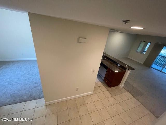 9745 Touchton Rd Unit 2522, Jacksonville, FL 32246 - kitchen featuring light carpet, baseboards, and light tile patterned floors