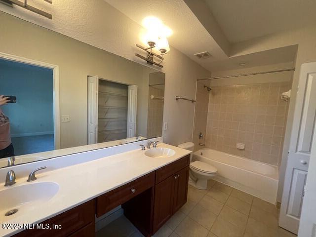 9745 Touchton Rd Unit 2522, Jacksonville, FL 32246 - full bath with tile patterned flooring, shower / bathtub combination, double vanity, and toilet