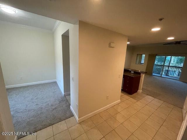 9745 Touchton Rd Unit 2522, Jacksonville, FL 32246 - unfurnished room featuring light colored carpet, baseboards, recessed lighting, light tile patterned floors, and crown molding