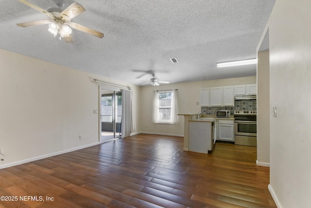 726 Calico Jack Way, Green Cove Springs, FL 32043 - kitchen featuring stainless steel appliances, ceiling fan, open floor plan, a textured ceiling, and dark wood-style flooring