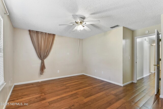 726 Calico Jack Way, Green Cove Springs, FL 32043 - empty room with wood finished floors, ceiling fan, a textured ceiling, and baseboards