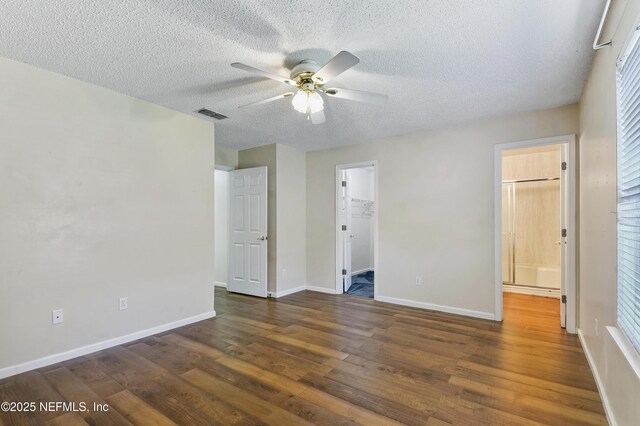 726 Calico Jack Way, Green Cove Springs, FL 32043 - unfurnished bedroom featuring wood finished floors, a textured ceiling, baseboards, a spacious closet, and a closet