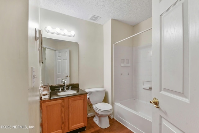 726 Calico Jack Way, Green Cove Springs, FL 32043 - full bathroom featuring toilet, wood finished floors, vanity, a textured ceiling, and bathing tub / shower combination