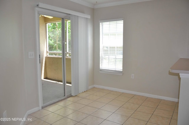 spare room with crown molding and baseboards