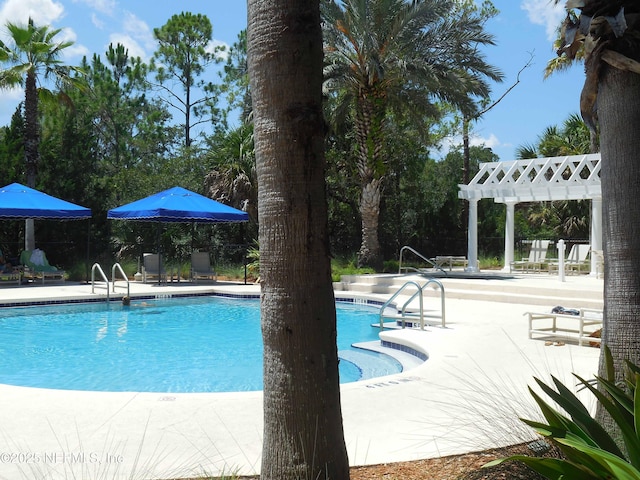 community pool featuring a pergola and a patio area