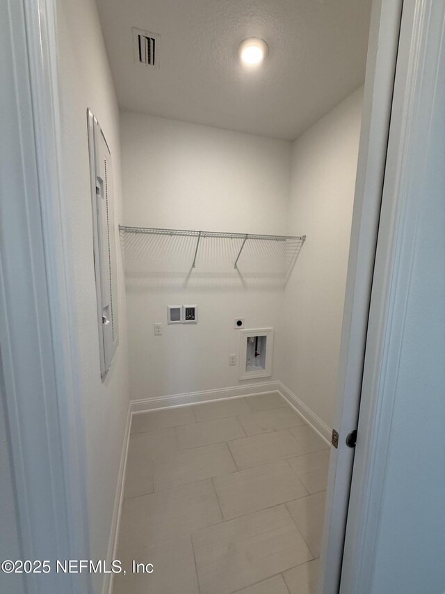 38 Mulberry Rd, Palm Coast, FL 32164 - laundry area featuring electric dryer hookup, baseboards, washer hookup, and a textured ceiling