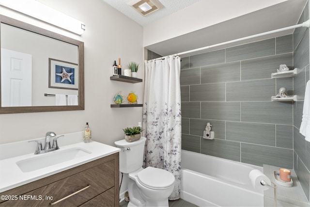 bathroom with toilet, vanity, and shower / bath combo