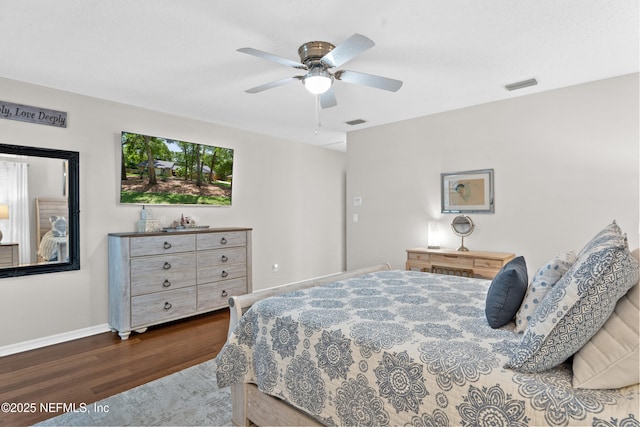 bedroom with wood finished floors, baseboards, and a ceiling fan