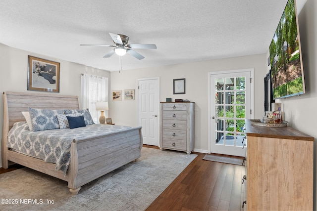 bedroom with dark wood finished floors, access to exterior, a textured ceiling, ceiling fan, and baseboards