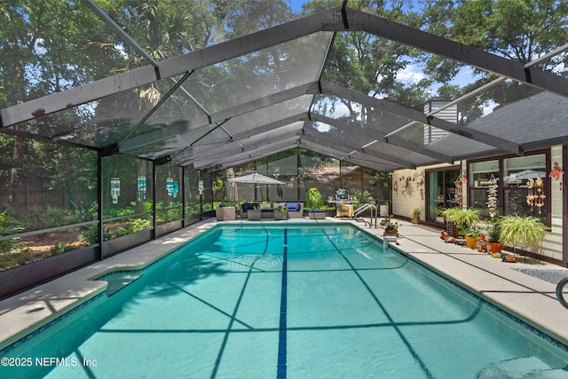 swimming pool with an outdoor living space, a patio, and glass enclosure