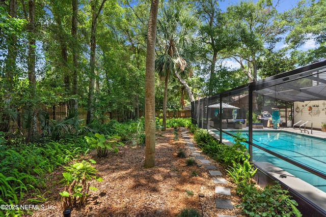 fenced backyard featuring glass enclosure