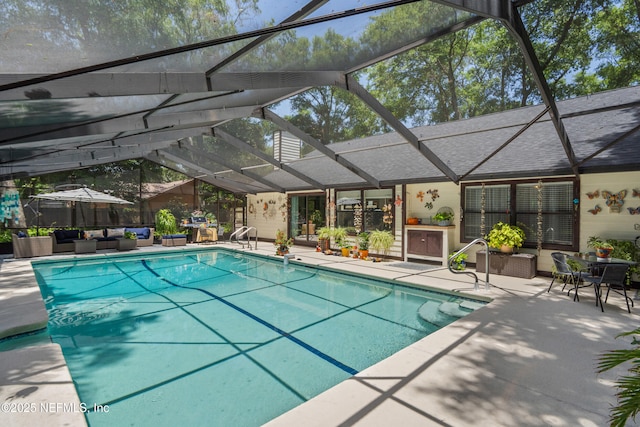 view of swimming pool featuring an outdoor living space, a patio area, and a lanai