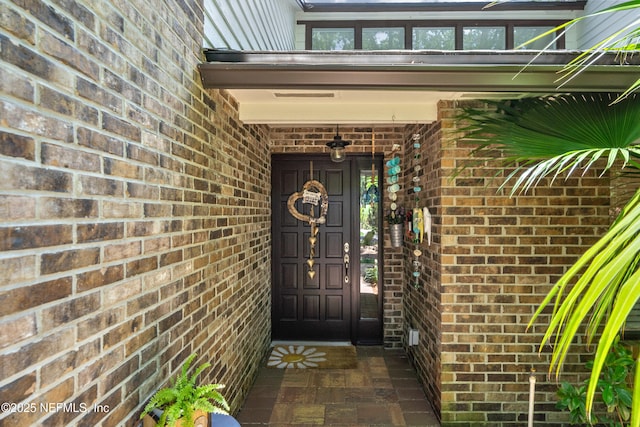 doorway to property with brick siding