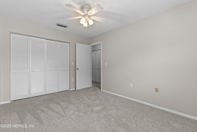 347 Greencastle Rd Unit 46, Jacksonville, FL 32225 - unfurnished bedroom featuring carpet flooring, baseboards, a closet, a textured ceiling, and a ceiling fan
