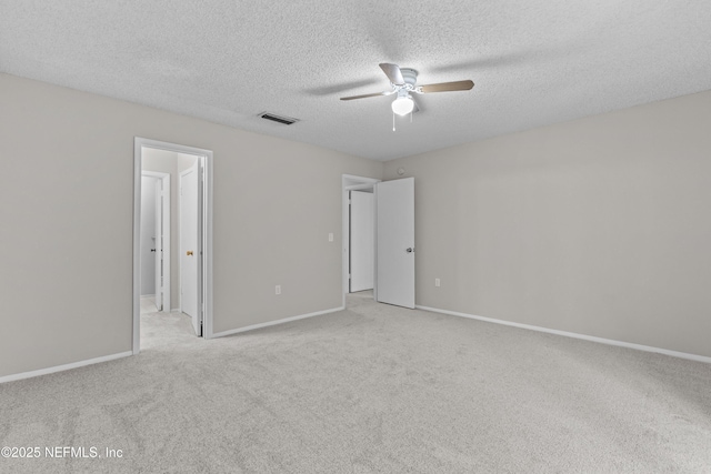 347 Greencastle Rd Unit 46, Jacksonville, FL 32225 - unfurnished bedroom with light colored carpet, a textured ceiling, baseboards, ceiling fan, and connected bathroom