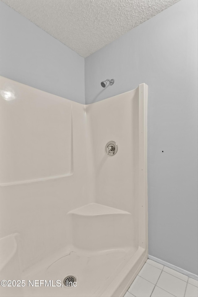 347 Greencastle Rd Unit 46, Jacksonville, FL 32225 - bathroom with a shower, a textured ceiling, and tile patterned floors