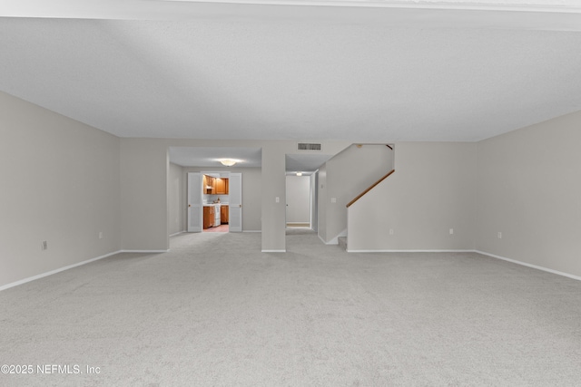 347 Greencastle Rd Unit 46, Jacksonville, FL 32225 - unfurnished living room with light carpet, stairway, and baseboards