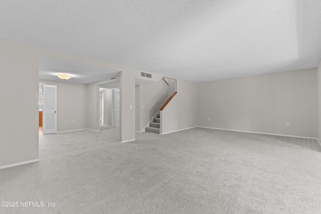 347 Greencastle Rd Unit 46, Jacksonville, FL 32225 - unfurnished living room featuring a textured ceiling, stairway, carpet flooring, and baseboards