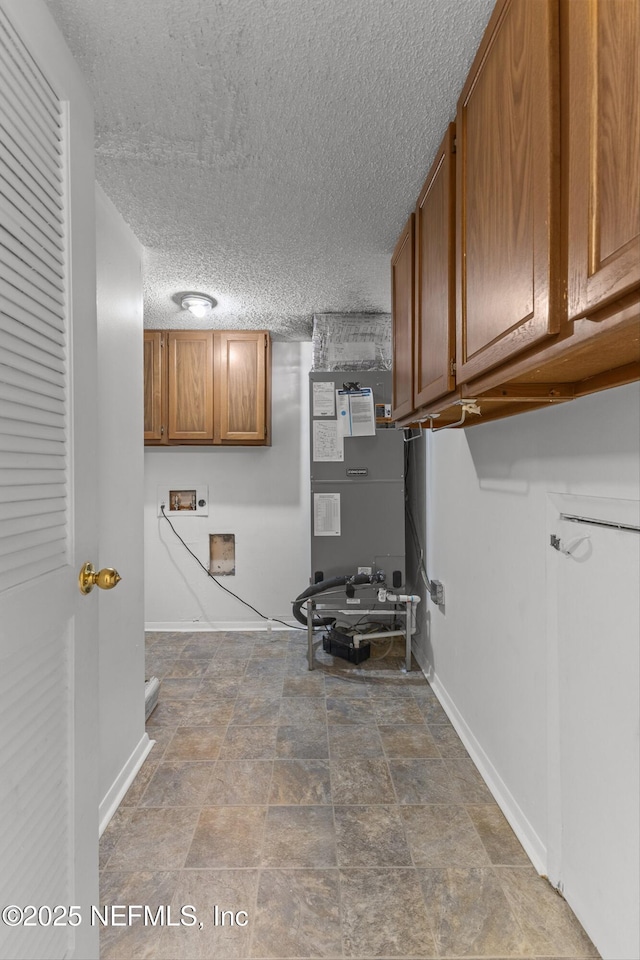 347 Greencastle Rd Unit 46, Jacksonville, FL 32225 - laundry area featuring cabinet space, baseboards, hookup for a washing machine, a textured ceiling, and stone finish flooring
