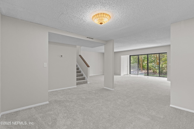 347 Greencastle Rd Unit 46, Jacksonville, FL 32225 - spare room with stairs, carpet floors, a textured ceiling, and baseboards