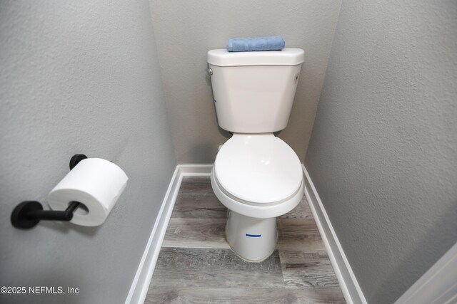 1207 Neva St, Jacksonville, FL 32205 - bathroom featuring toilet, wood finished floors, baseboards, and a textured wall