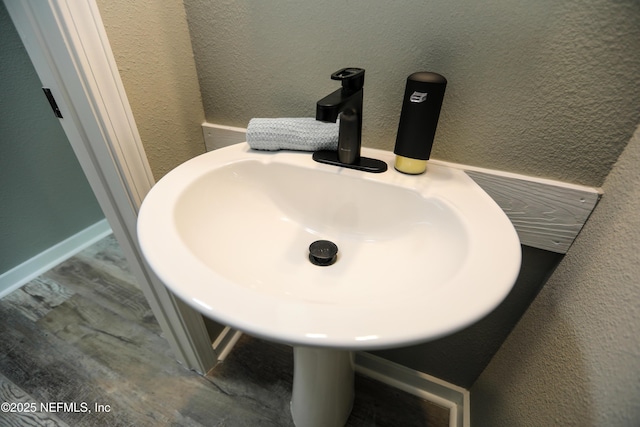 1207 Neva St, Jacksonville, FL 32205 - bathroom view of a sink, wood finished floors, and a textured wall