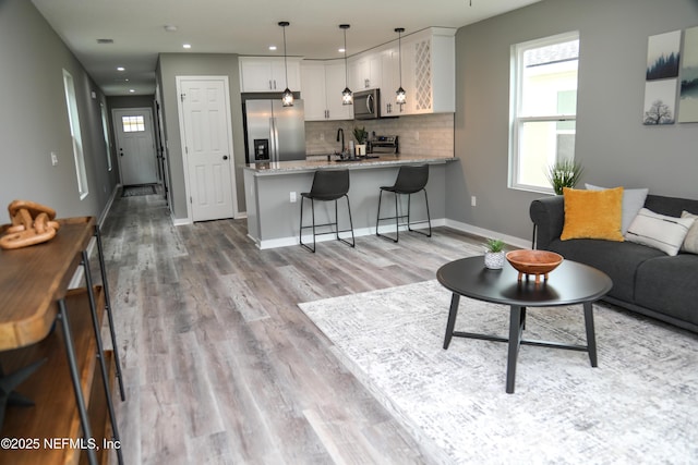 1205 Neva St, Jacksonville, FL 32205 - living area with light wood finished floors, baseboards, and recessed lighting