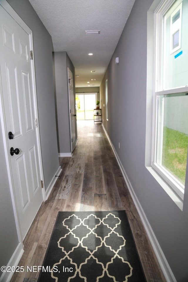 1205 Neva St, Jacksonville, FL 32205 - hallway with a textured ceiling, wood finished floors, and baseboards