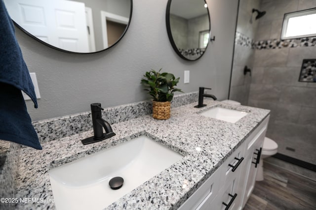 1205 Neva St, Jacksonville, FL 32205 - full bath featuring a tile shower, double vanity, toilet, and wood finished floors
