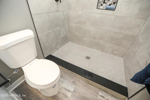 1205 Neva St, Jacksonville, FL 32205 - full bathroom featuring toilet, tiled shower, and wood finished floors